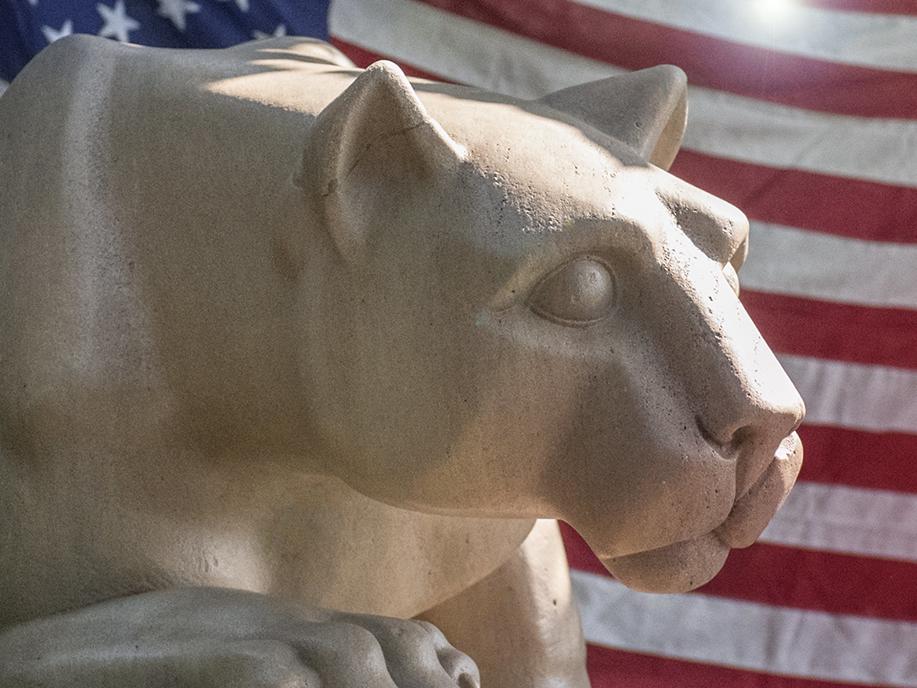 Nittany Lion Shrine with American flag in background