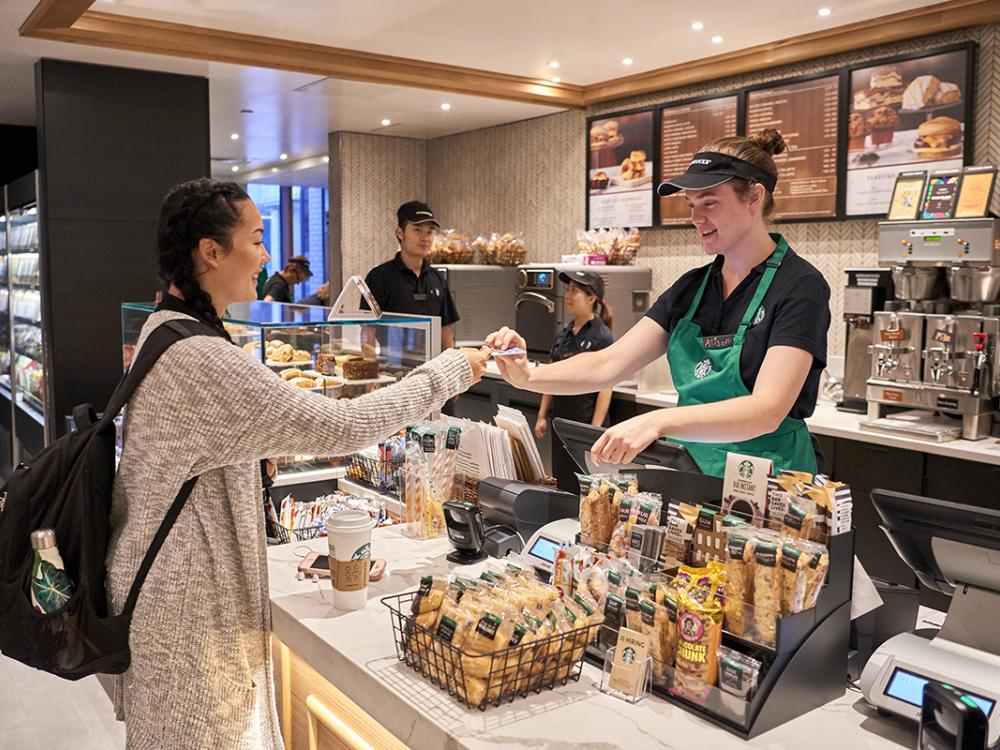 A student makes a purchase with her Penn State ID card at the Starbucks located in Pattee Library.