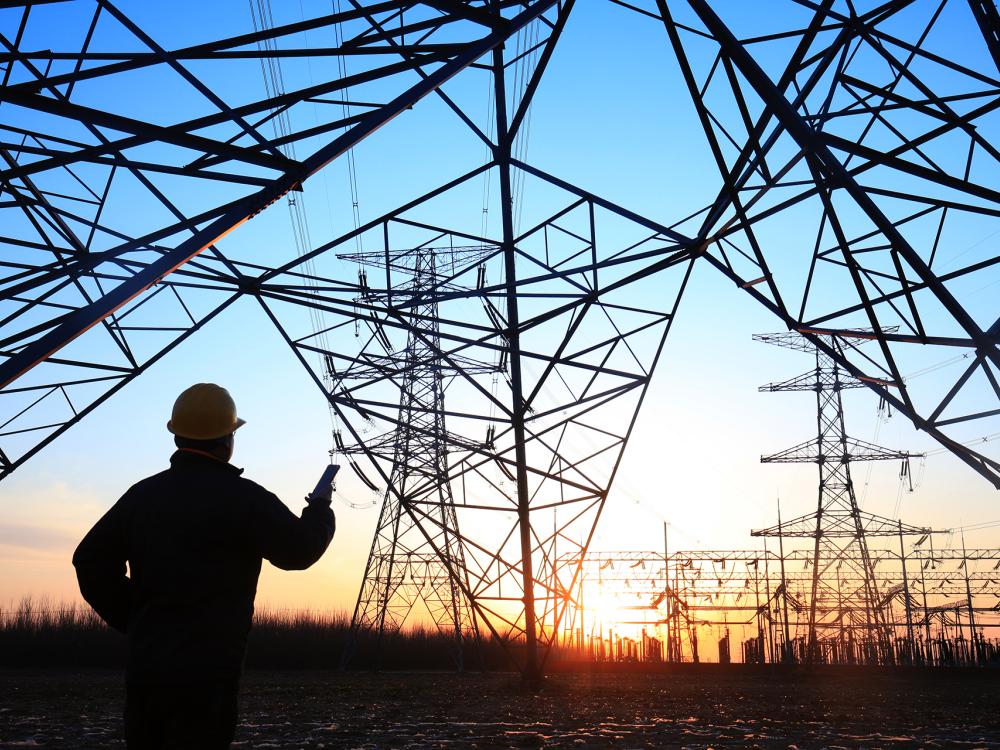 Electricity worker and pylon silhouette