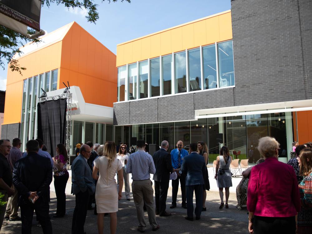 People stand outside building before event