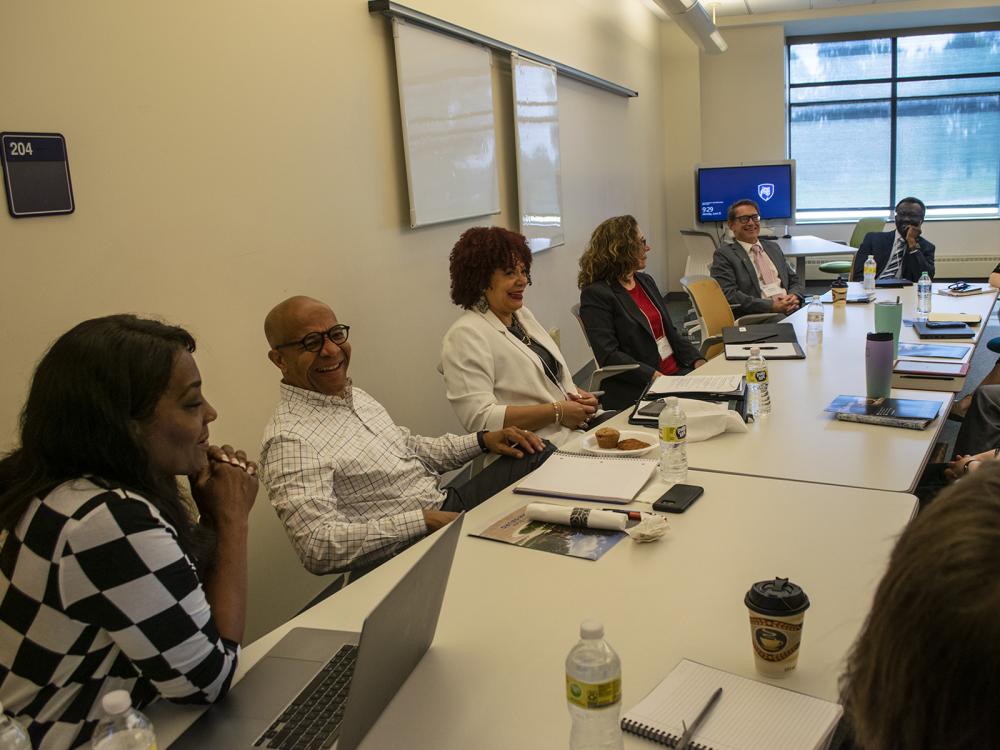 A team from Penn State Harrisburg talks while sitting around a large conference table