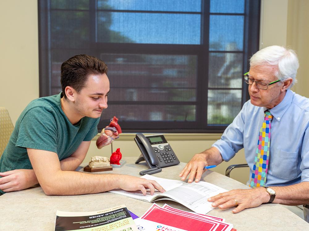 Ron Markle, director of Science and Premedicine majors in the Eberly College of Science, meets with a student in Ritenour Building, home to the college’s Office for Undergraduate Students, Penn State University Park.