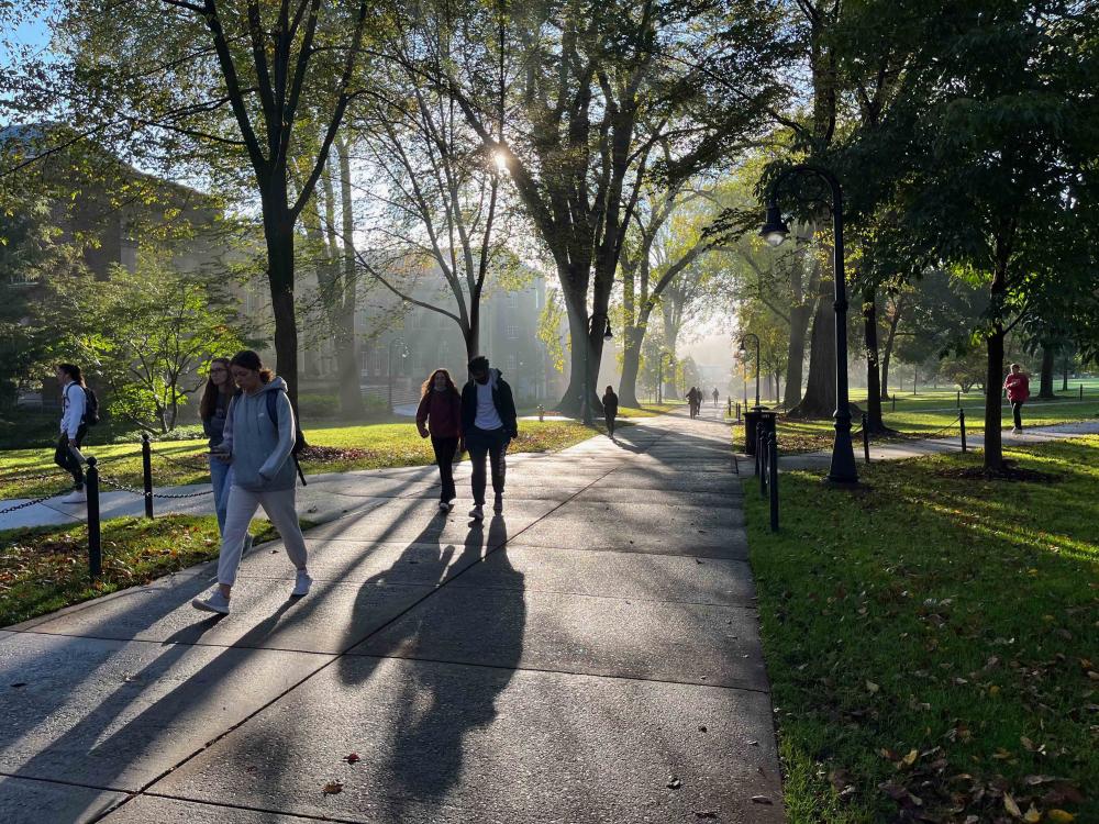 several students walking on a sidewalk at Penn State