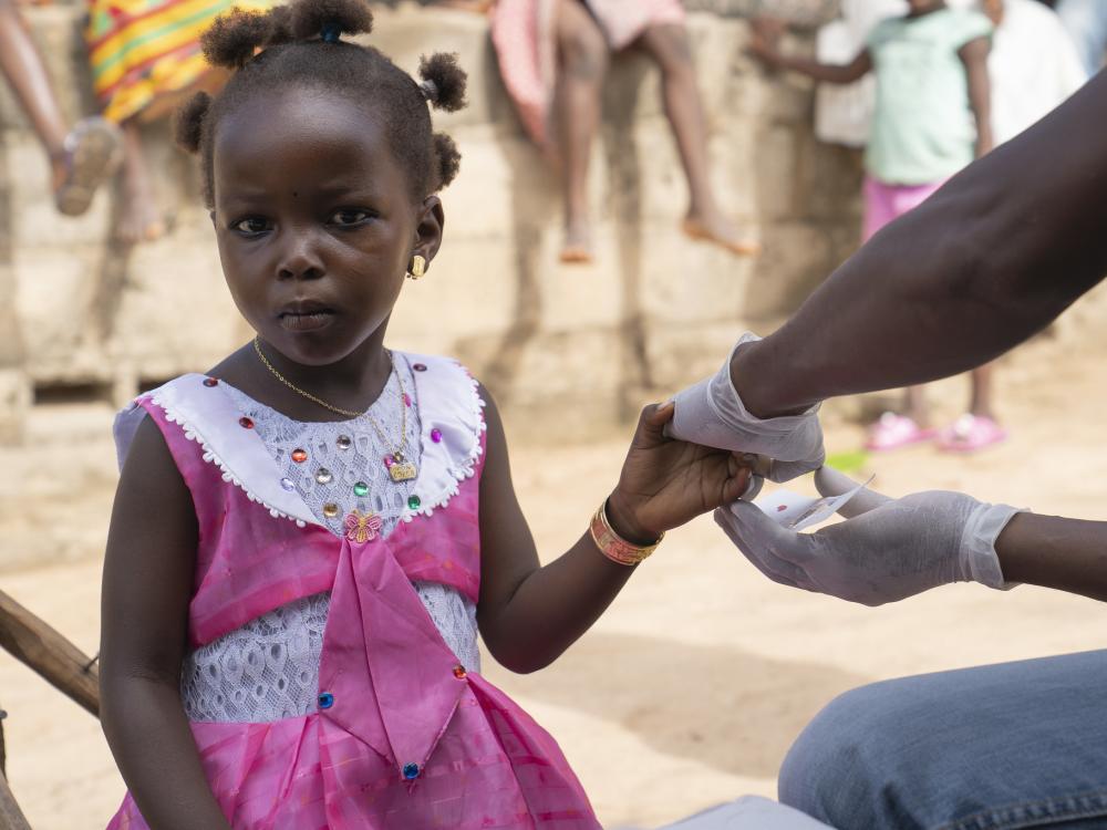 Girl receiving malaria test