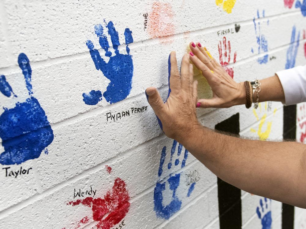 donors add handprints to new all hands on deck mural