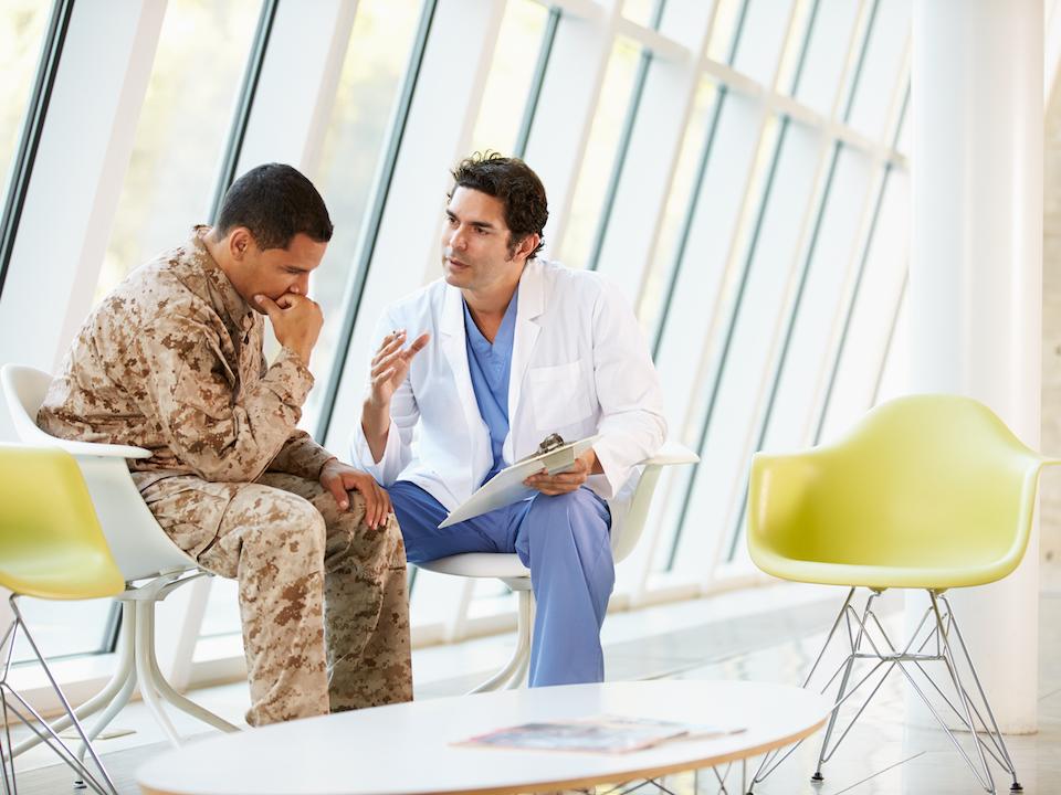 Doctor Counselling Soldier Suffering From Stress