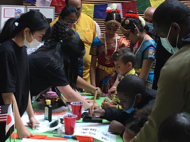 Children learning Chinese characters at a festival