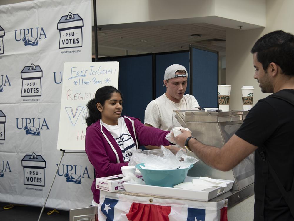 Student service ice cream in front of PSU votes sign