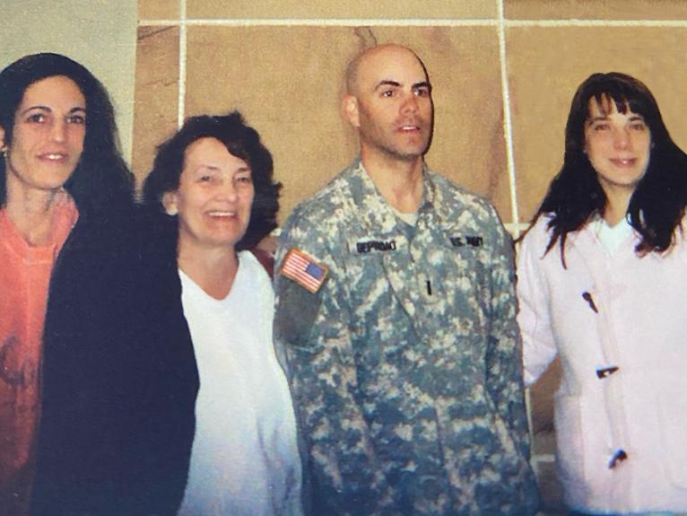 Soldier standing with three family members