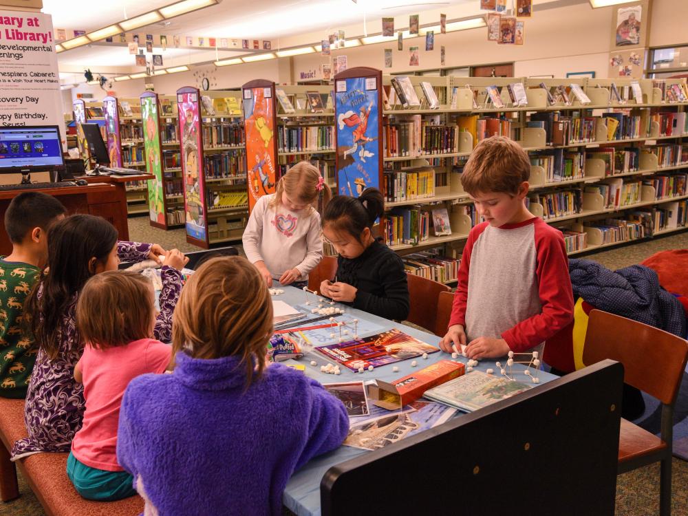 Kids at a table in a library