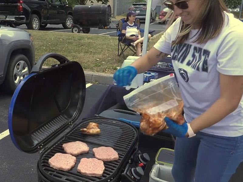 Grilling meat at a tailgate party