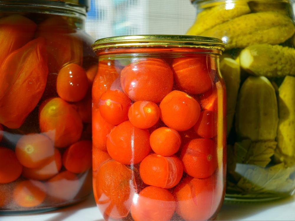 Tomatoes and other vegetables in glass jars