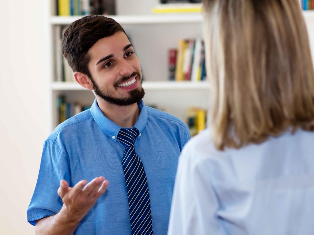 smiling businesman talking with colleague