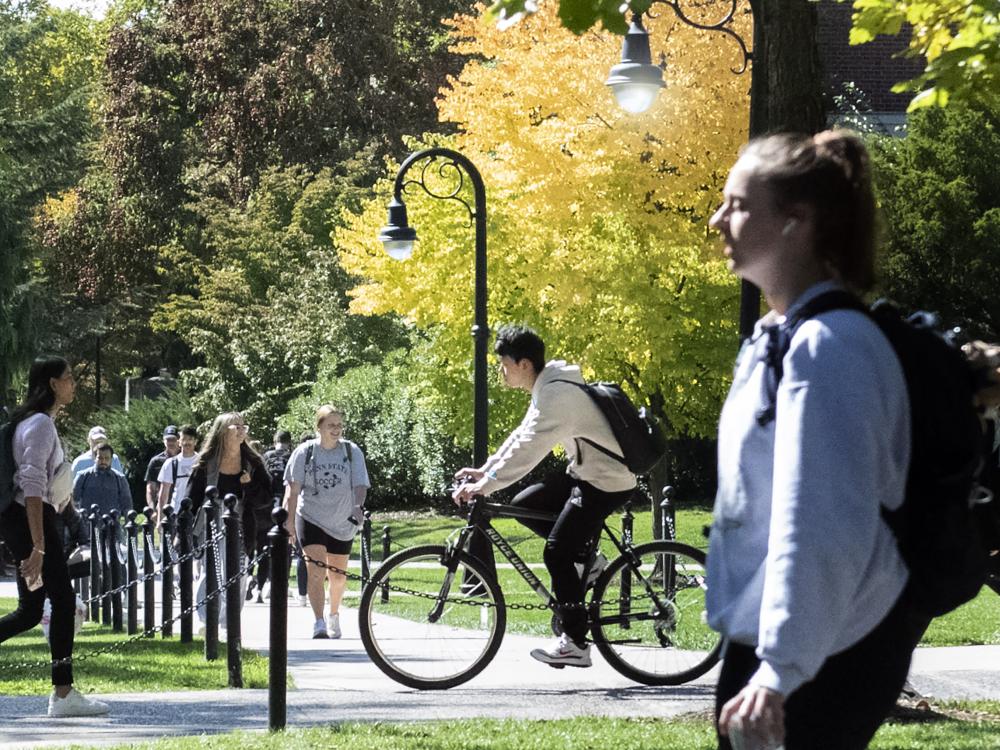 students biking and walkin on University Park campus