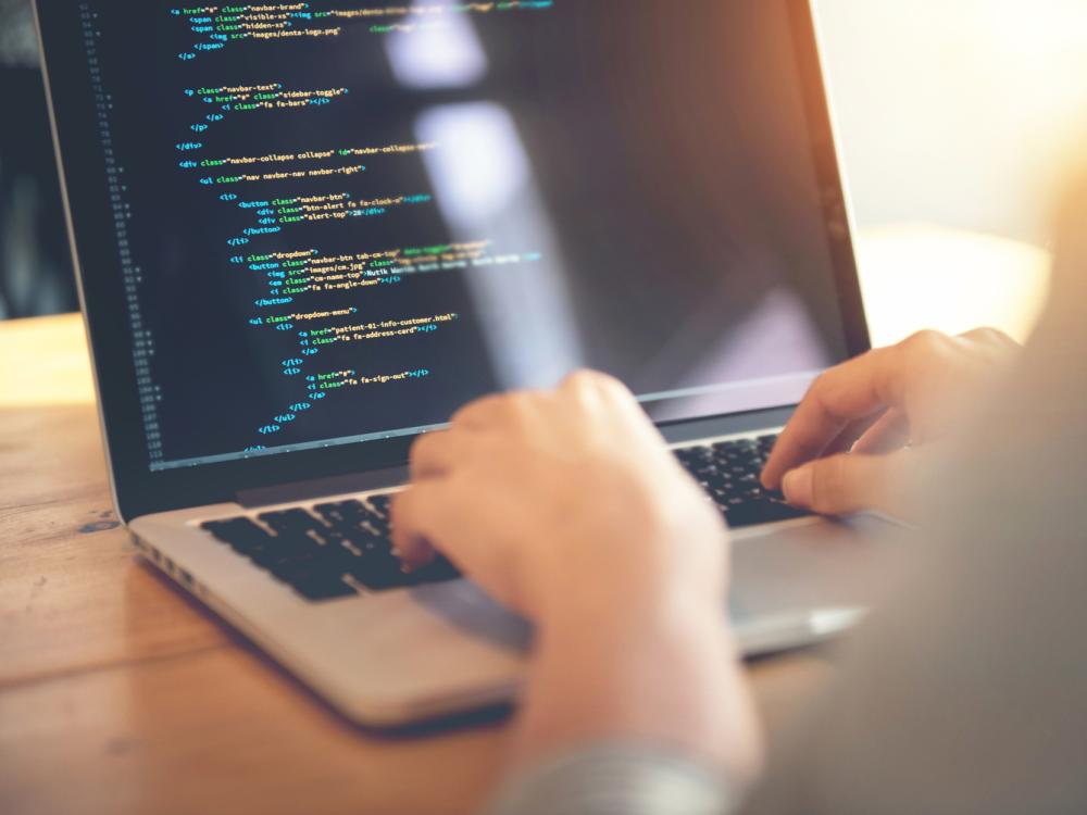 A computer programmer uses a laptop