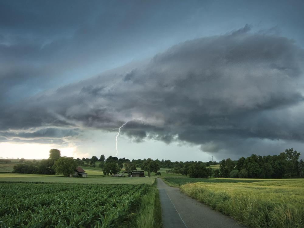 A thunderstorm over a farm field 