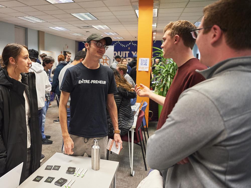 Group of students talking to each other during a tabling event