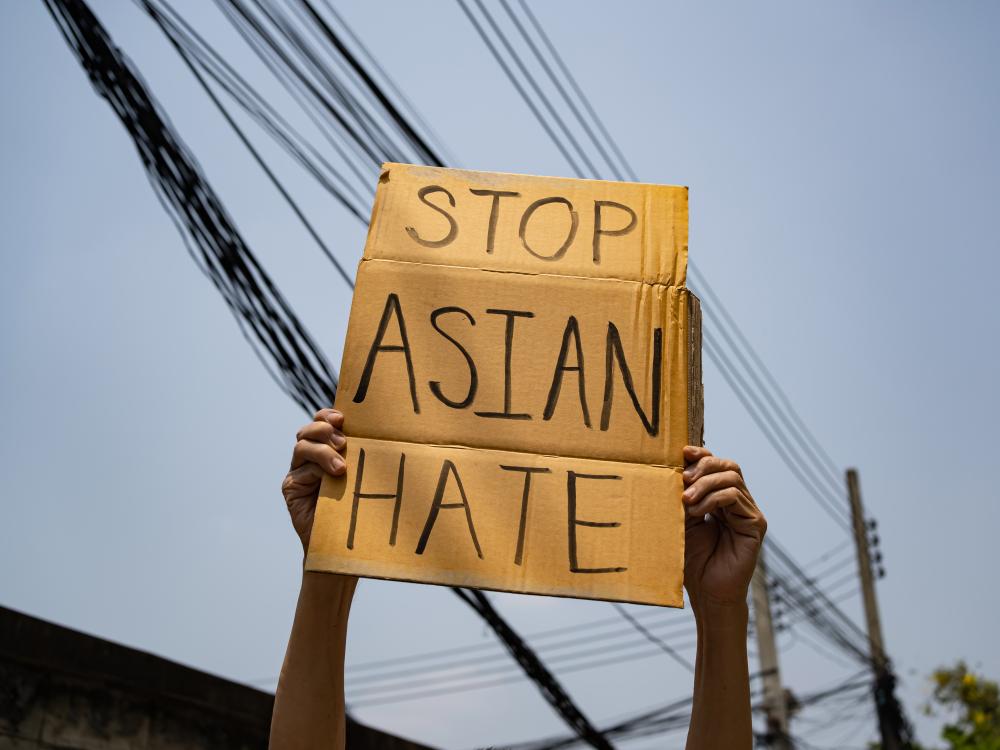 Cardboard sign that says: "Stop Asian Hate" 