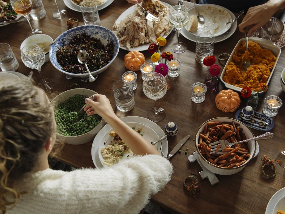 Girl having a huge meal while sitting at dining table.