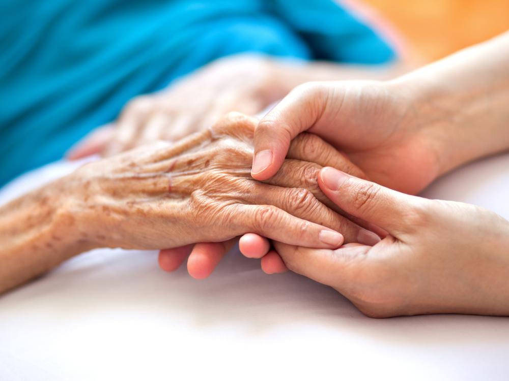 Doctor holding patient's hand