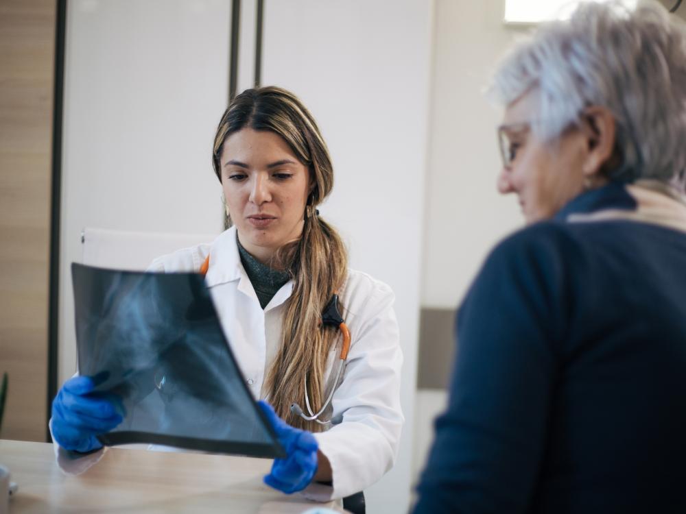 Older woman and her doctor look at a hip x-ray