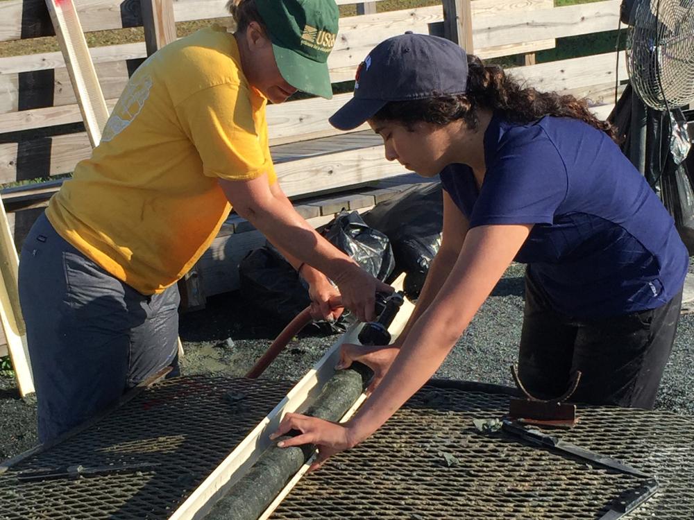 Victoria Fortiz collects a core sample from the Howards Tract site in Maryland