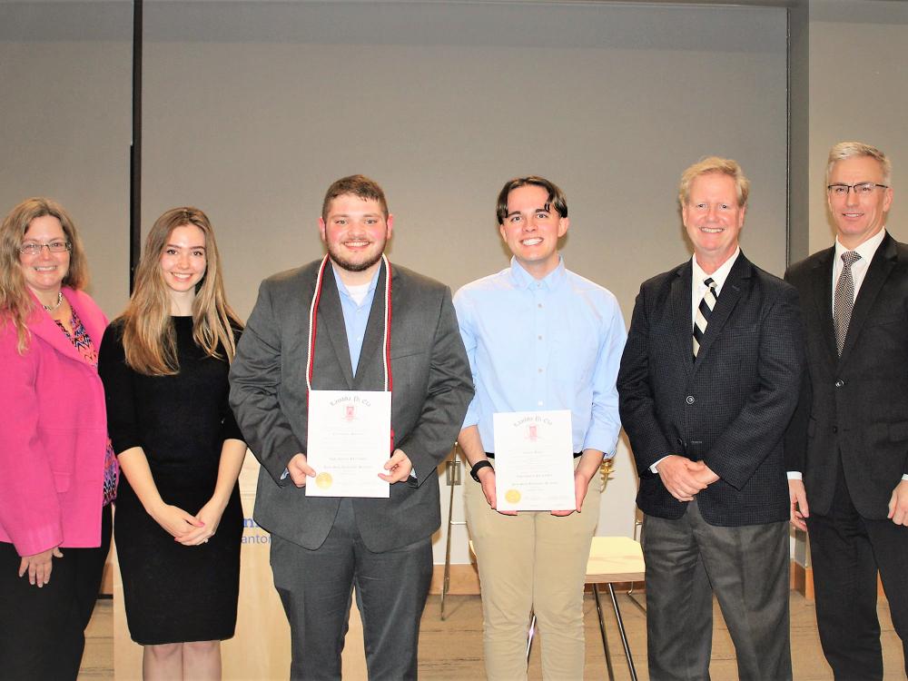 Lambda Pi Eta honor cord recipients pose with faculty members after cording ceremony