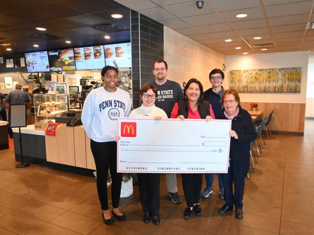 A group of people for a check presentation