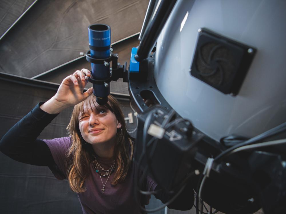 Radovic looks through eyepiece of telescope