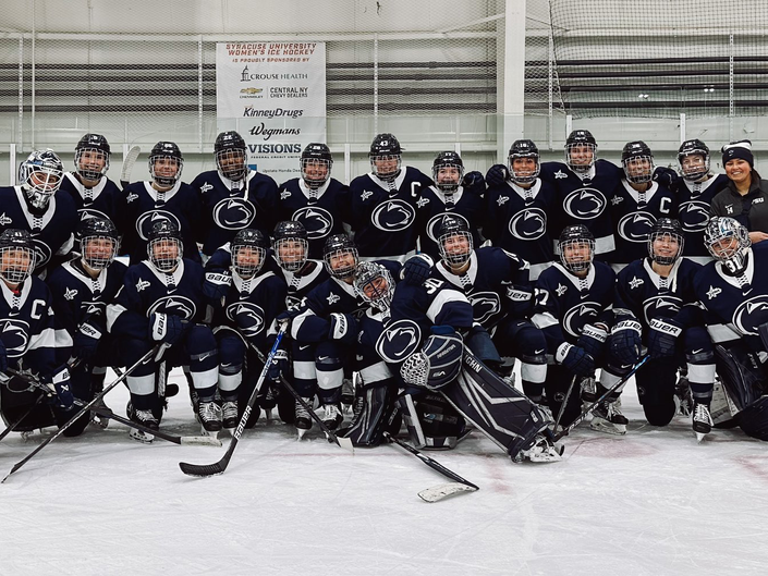 Women's ice hockey team poses together in group photo
