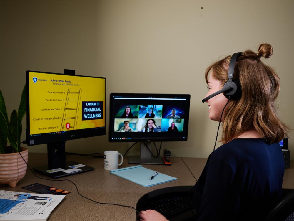 Person watching computer webinar at a desk