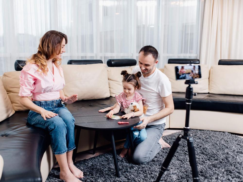 Family taking a photo of their child.