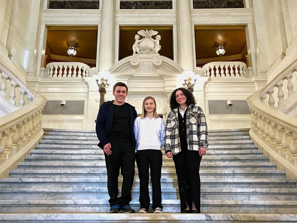 Three undergraduate research students on the Capitol steps