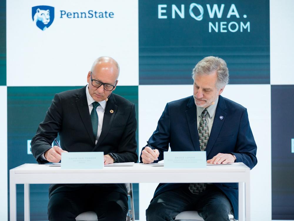 Bruce Logan, right, and Gavin van Tonder participate in the ceremonial signing of the master agreement between ENOWA and Penn State.
