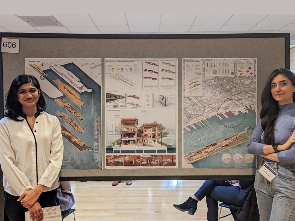 Anjali Gopalakrishnan at left and Parinaz Mansourimajoumerd in front of their research poster.