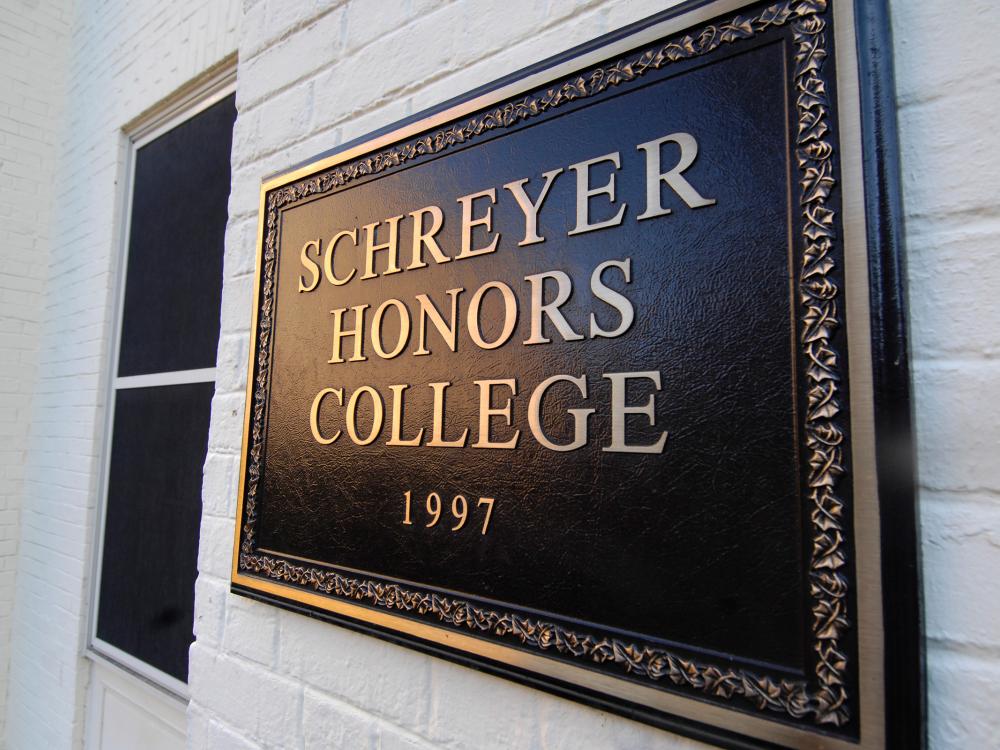 plaque that reads "schreyer honors college 1997"