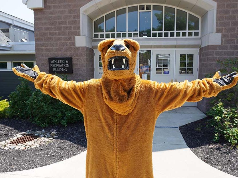 The Nittany Lion standing with open arms.