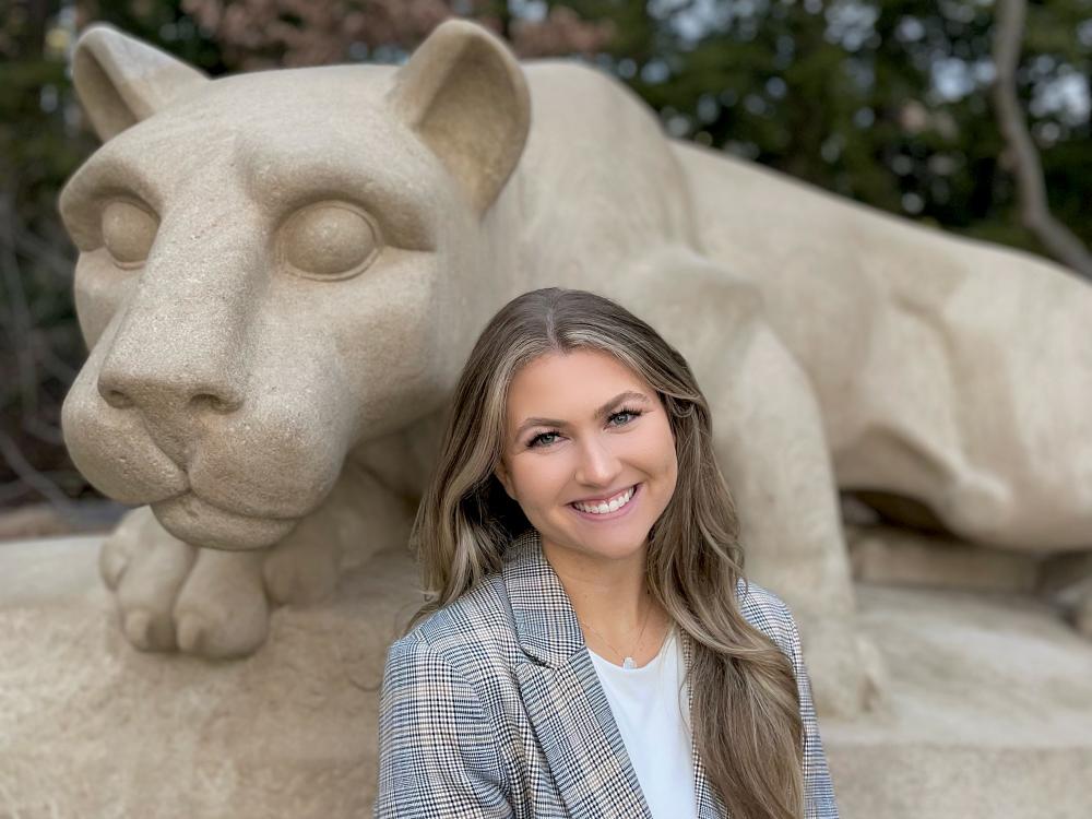 Rachel Storey stands before the Nittany Lion Shrine.