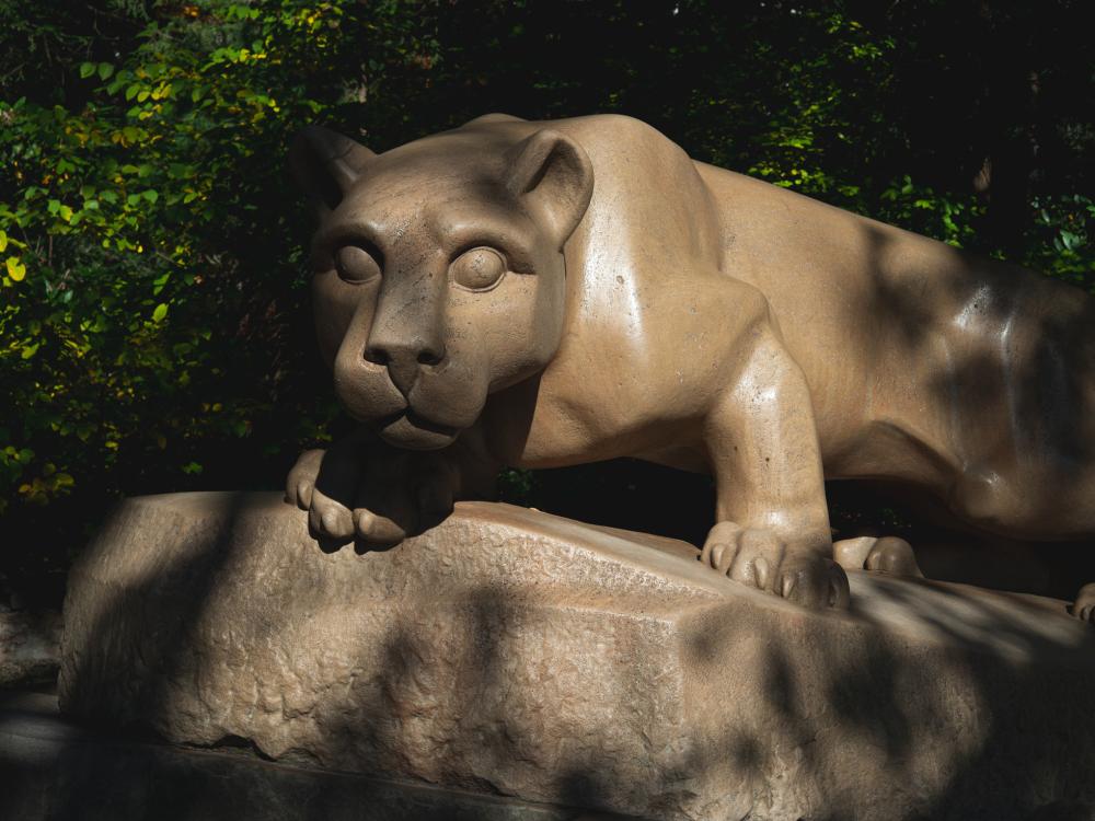 Nittany Lion shrine with dappled shadows from leaves