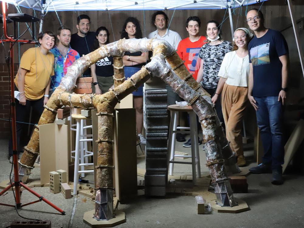 The ForMat Lab researchers involved in the MycoCreate project pose behind the first version of the installation.