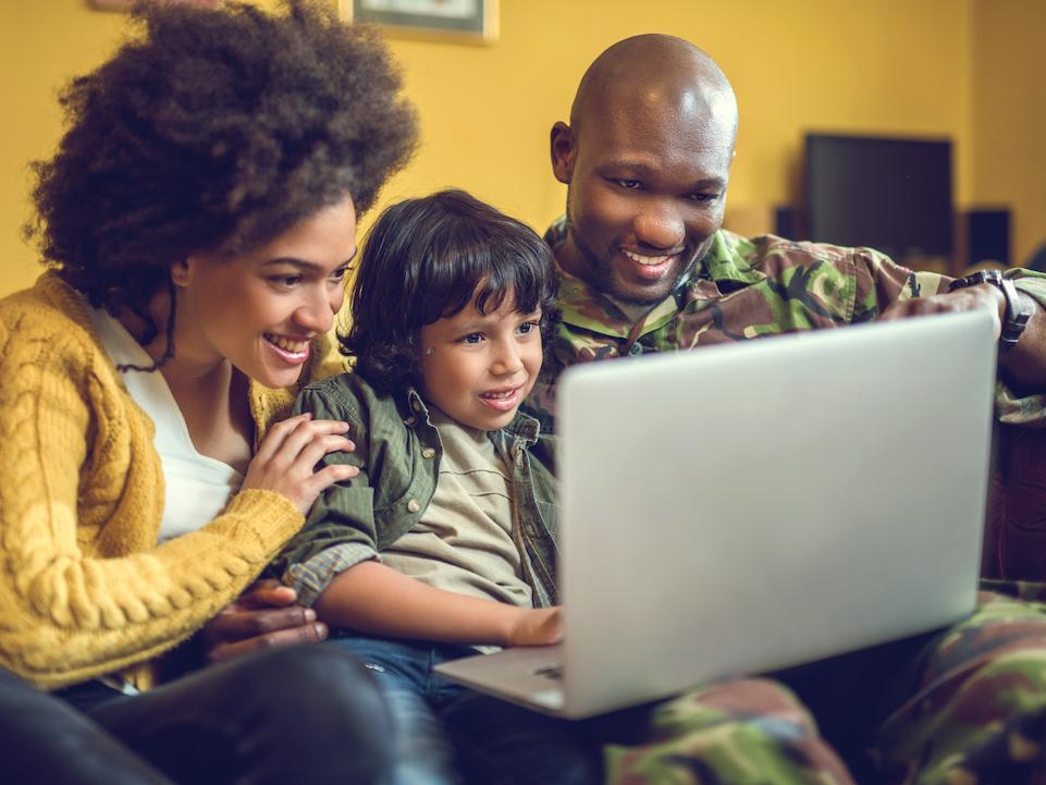 Military family looking at laptop computer