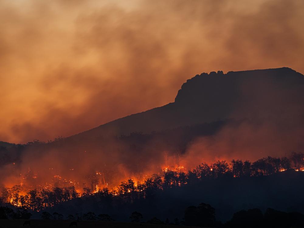 Landscape photo of a mountain rage experiencing a forest fire