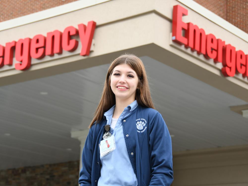 Radiological Science student smiling outside of healthcare facility