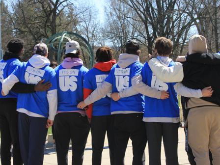 Students stand arm in arm during the Men Against Violence walk at Penn State University Park