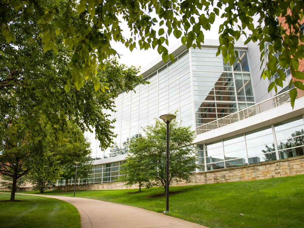 A photo of the front of the Business Building in the summer.