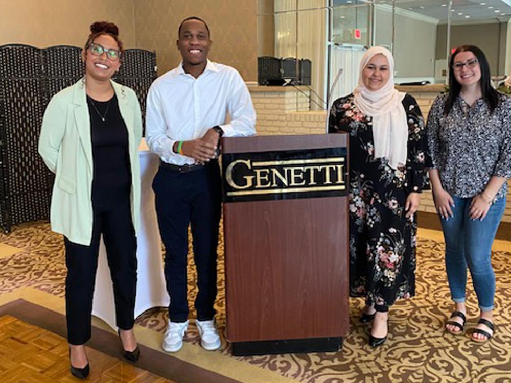 Group photo of four people at the Northeastern Association of Criminal Justice Sciences conference