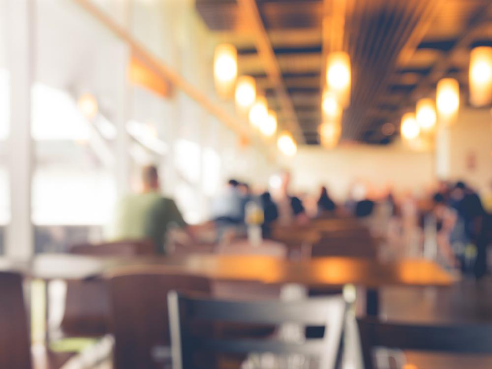 stock photo of restaurant with people and objects in the blurred background 