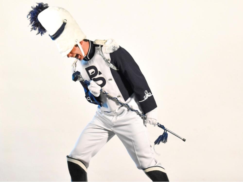 drum major in uniform strikes singing pose