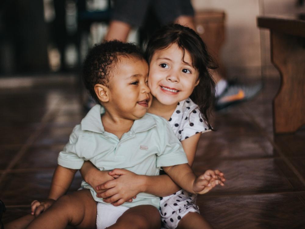 two young children hugging