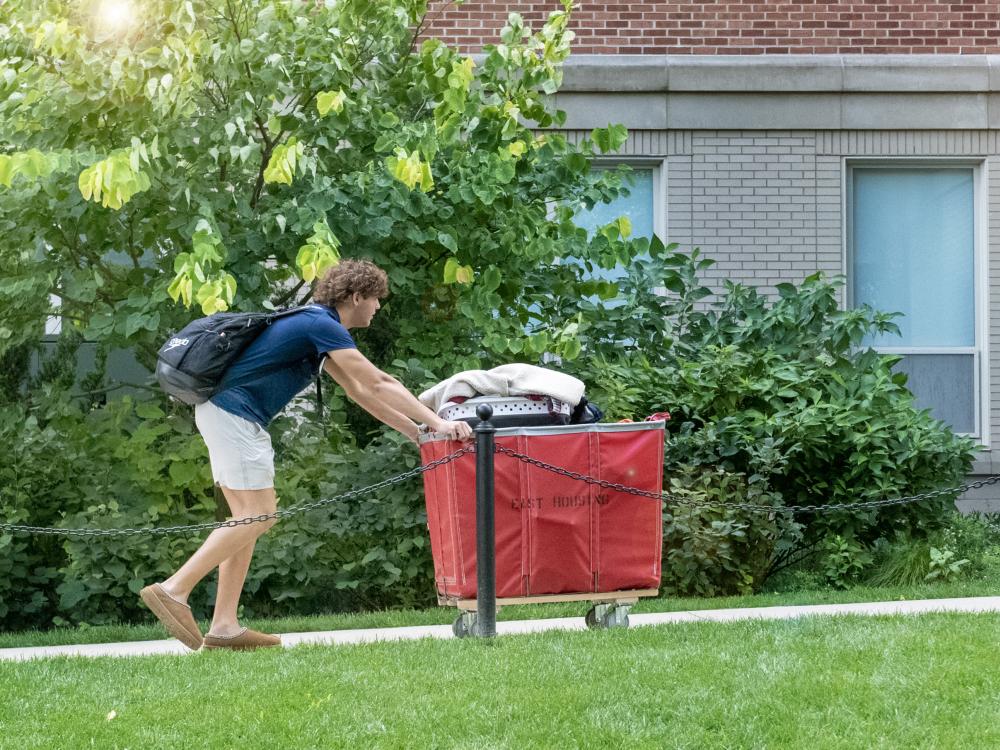 student moving belongings into residence hall